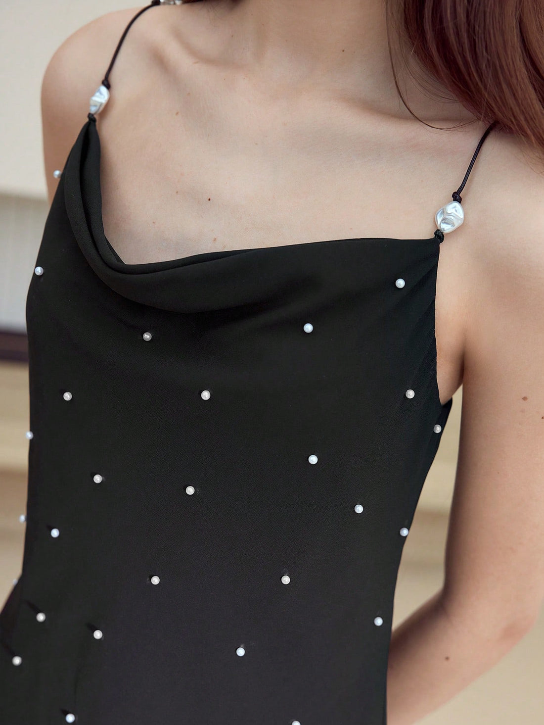Step into charm with the Faux Pearl Decor Cami Dress, where delicate pearl accents meet a flirty silhouette. Perfect for turning heads at brunch or dancing the night away, this dress adds a playful touch of elegance to any occasion. Feel effortlessly chic and ready to sparkle wherever you go!