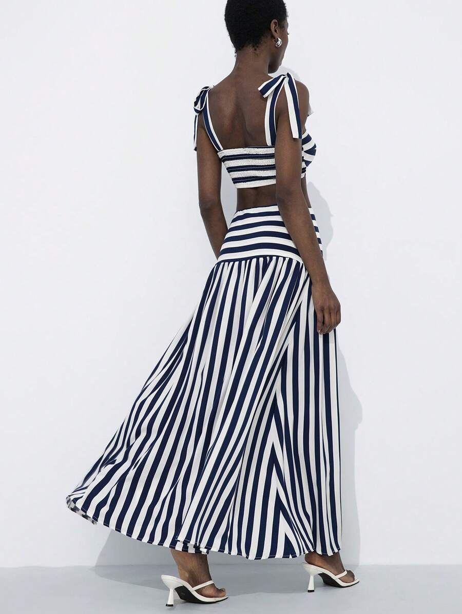 Navy and white striped two-piece set with tie-strap crop top and flowy maxi skirt