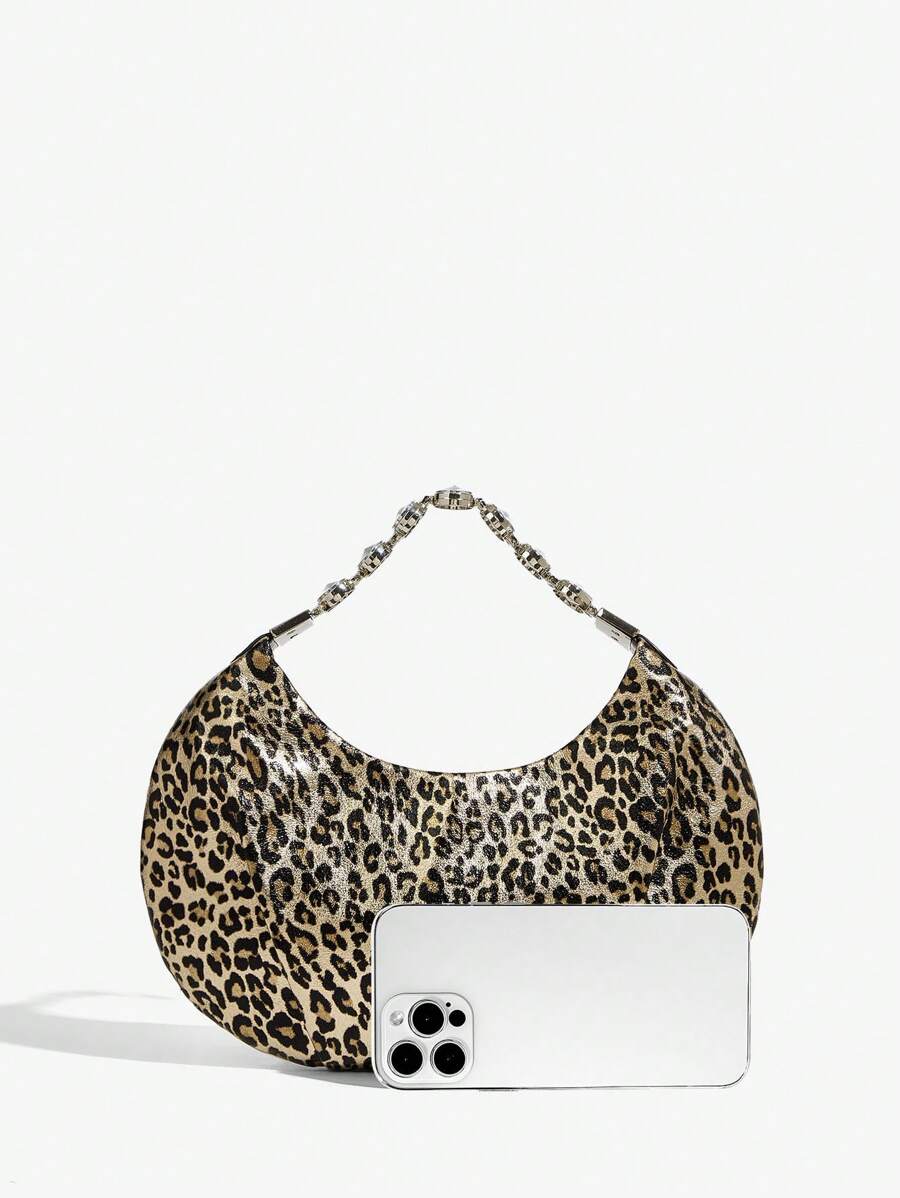 Close-up view of stylish bling leopard print top handle bag for elegant evening events and parties with leopard print, bling finish, top handle for party styling