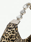 Close-up view of stylish bling leopard print top handle bag for elegant evening events and parties with leopard print, bling finish, top handle for party styling