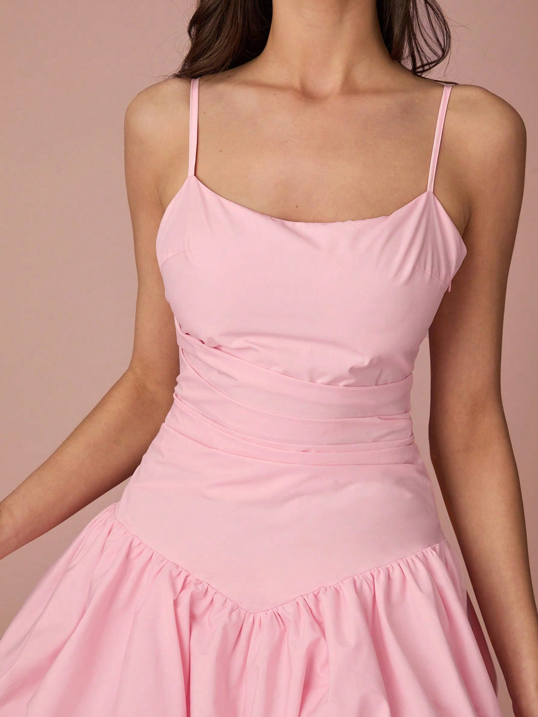 This elegant pink pleated mini dress is the perfect addition to your summer wardrobe. Whether you're headed on a vacation, attending a party, or have a special occasion, this dress will have you looking and feeling your best. With its playful and flirty style, you'll turn heads wherever you go.