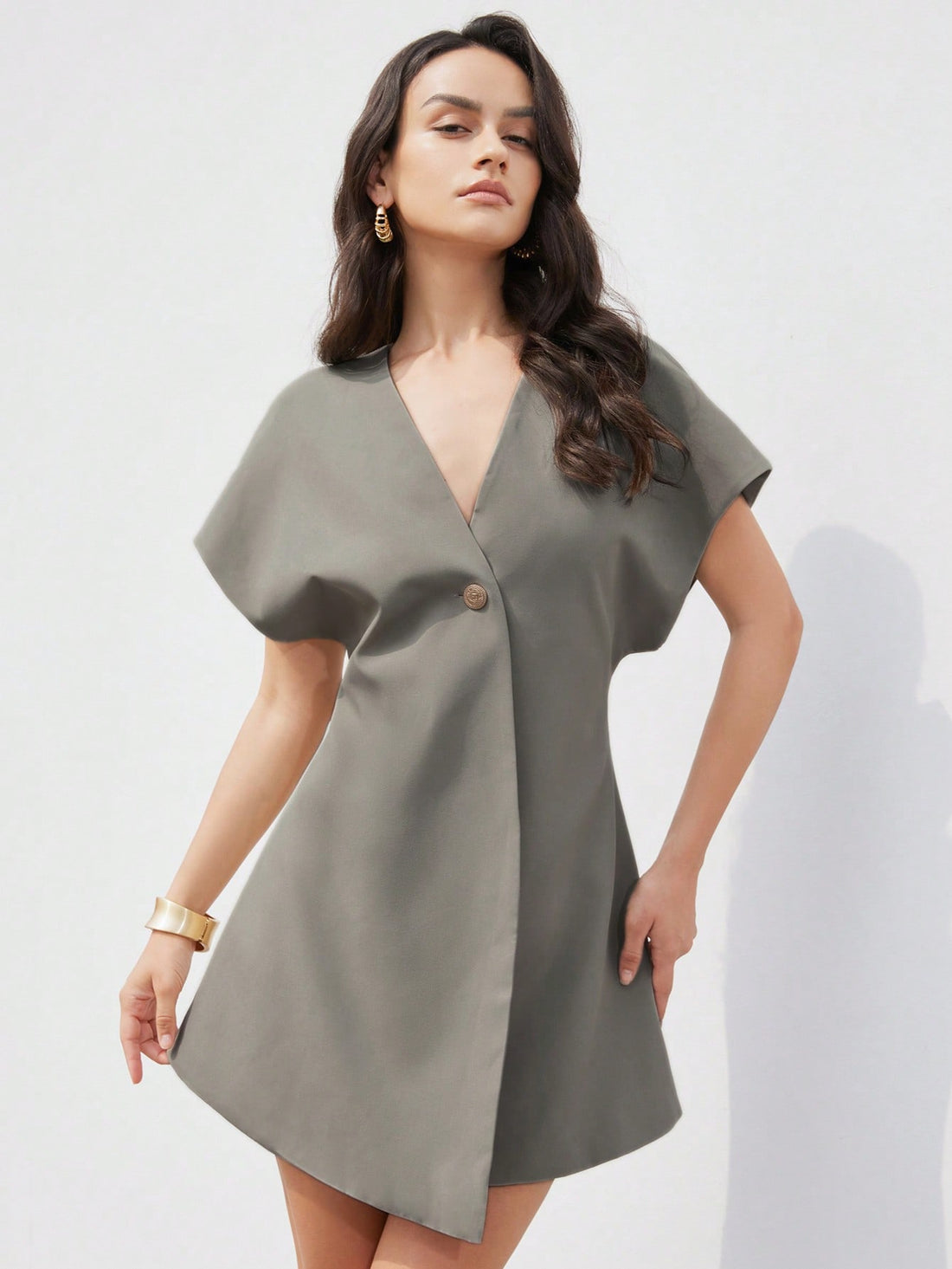 Step out in style with this playful yet elegant asymmetric short dress designed for the modern woman. Featuring a sculpted V-neck that flatters your neckline and a cinched waist that highlights your silhouette, this minimalist piece brings effortless charm to any occasion. Its unique cut adds a fun twist to classic elegance, making it perfect for day-to-night wear. Embrace your confidence and let your outfit do the talking!