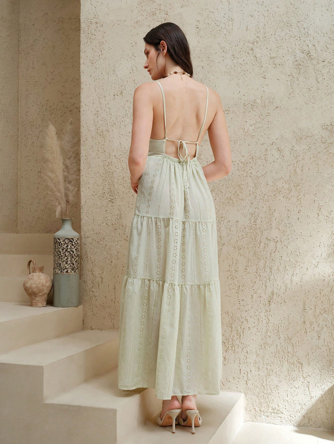 Embrace effortless summer style with this boho chic green sleeveless dress, designed for the modern woman seeking comfort without compromise. The tiered silhouette creates graceful movement and visual dimension, while delicate eyelet embroidery adds refined texture and breathability. Cut from lightweight fabric, this versatile piece transitions seamlessly from casual daytime outings to relaxed evening gatherings. The sleeveless design keeps you cool during warm months, and the flowing length offers elegant 