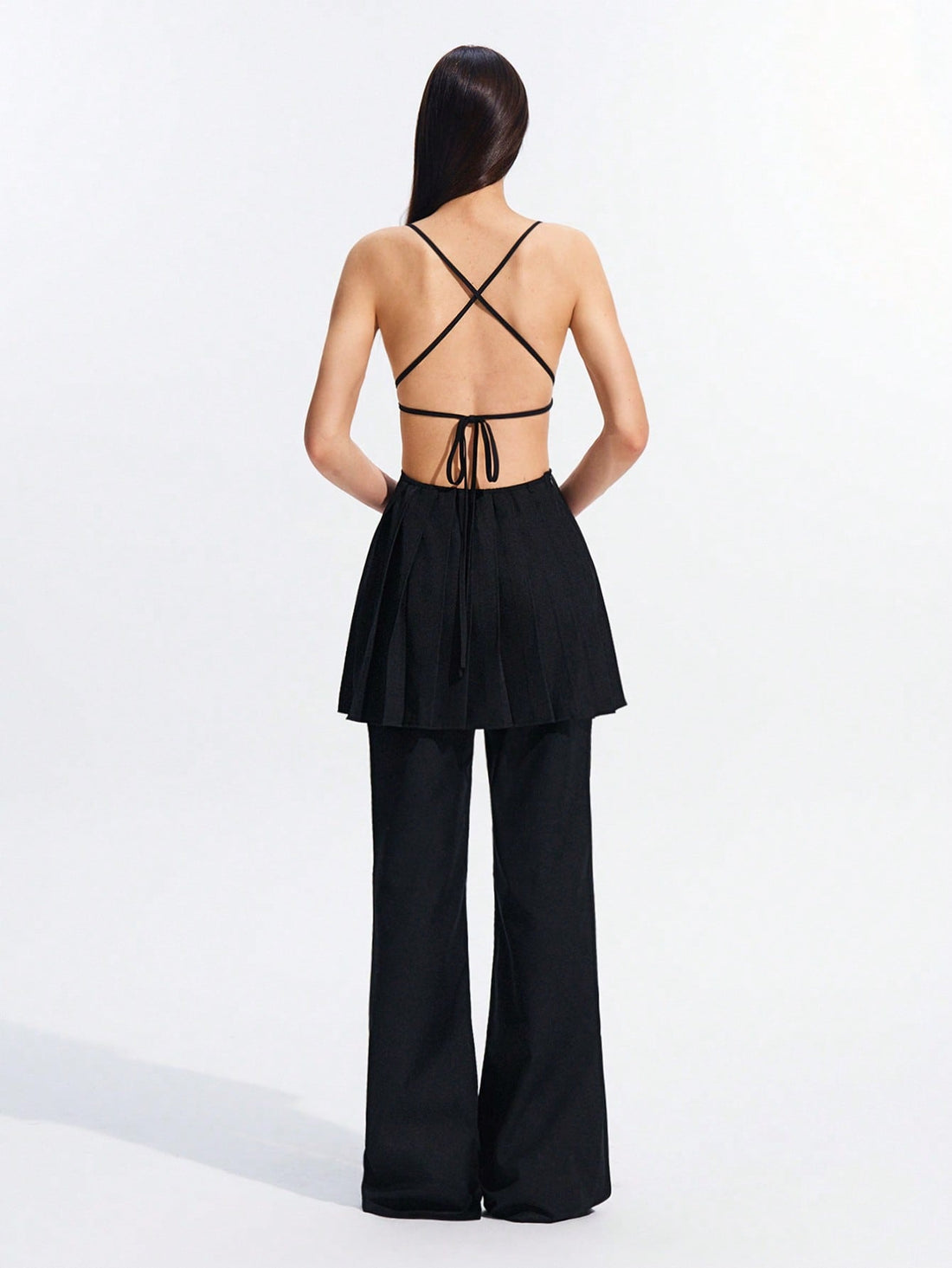 Step into the spotlight with this chic black backless dress, designed to turn heads all spring and summer. Featuring playful strappy details and flattering ruching, it effortlessly combines elegance with a flirty vibe. Perfect for warm evenings and stylish outings, this dress lets you show off your confident, fun-loving side with every step.