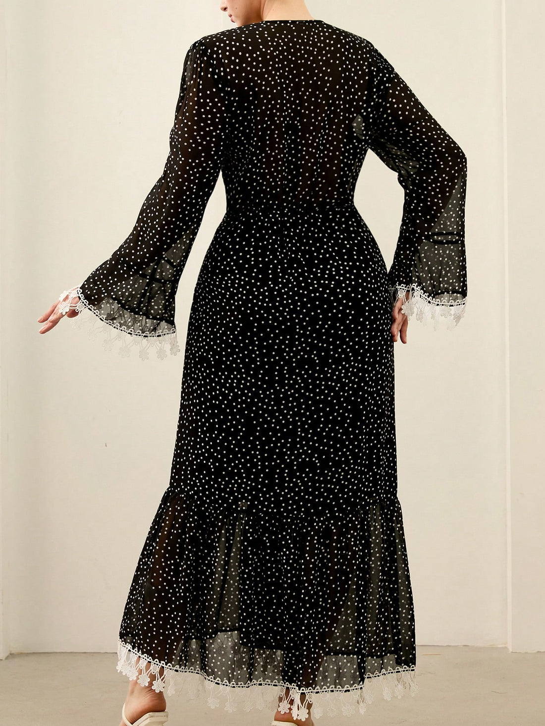 Twirl into sophistication with this stunning plus-size dress that celebrates your curves in all the right ways. The classic black and white polka dot pattern brings timeless charm, while delicate sheer fabric and intricate lace trim add an undeniably elegant touch. Perfect for date nights, special occasions, or whenever you want to feel absolutely fabulous. This versatile piece transitions seamlessly from day to evening, proving that style has no size limits. Embrace your inner fashionista and make a statem