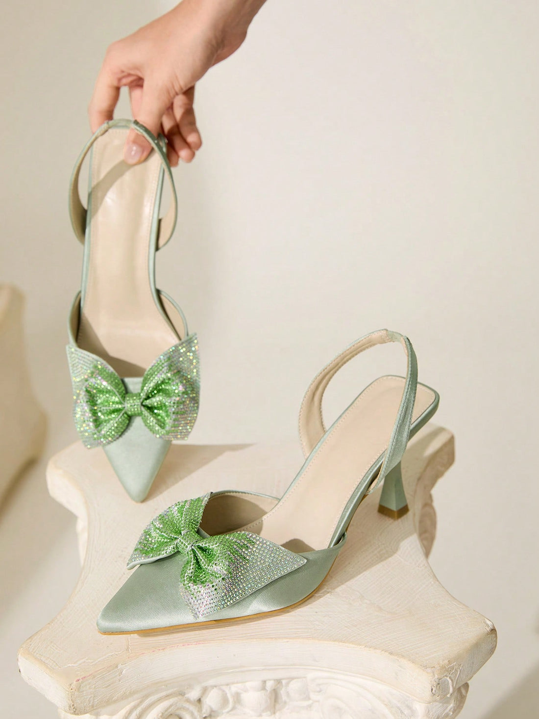 Elevate your style with these colorful pumps adorned with a playful rhinestone bow. Step up your fashion game and add a touch of whimsy to any outfit. These women's pumps are sure to make a statement and turn heads with their unique design.