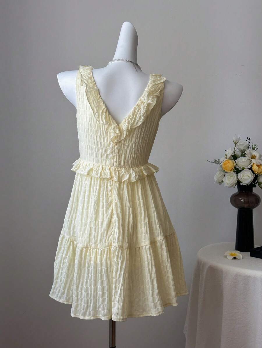 Get ready to slay your summer vacation style with this Stylish Textured V-Neck Dress. The ruffle trim adds a flirty touch while the v-neckline flatters your figure. Made with a textured fabric, this dress is perfect for effortless vacation vibes. Pack it in your suitcase and be ready for any adventure!
