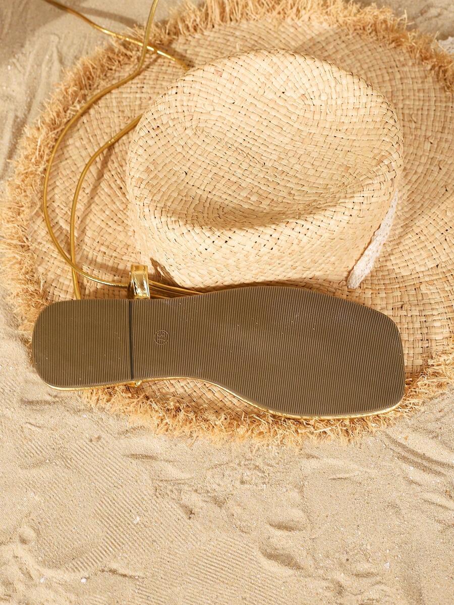 Step into summer with these chic gold thong sandals, perfect for adding a touch of sparkle to your vacation wardrobe. Lightweight and flat, they tie comfortably around your ankles, making every stroll feel effortless and stylish. Whether you're beach-bound or exploring sunny streets, these sandals bring playful elegance to your warm-weather adventures.