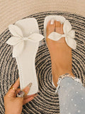 Off-white bow flat slide sandal shown on foot with square toe