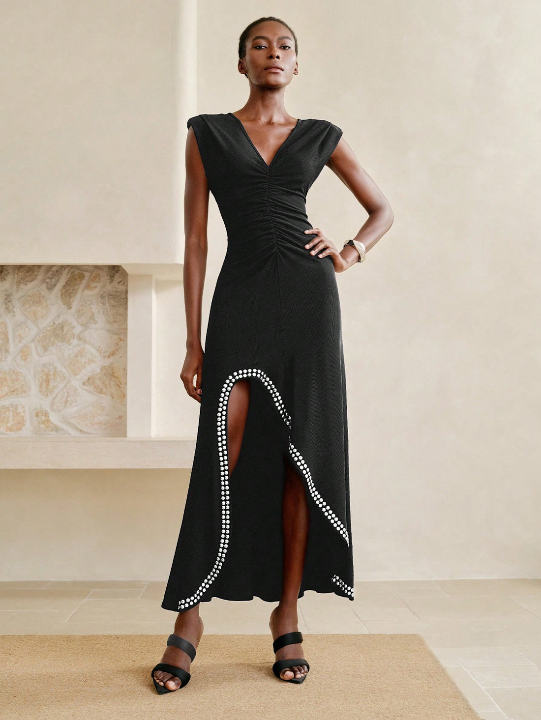 Step into summer with this playful black dress, sparkling with rhinestone accents that catch every eye. Its flattering V-neck and flirty asymmetrical ruffle hem add a fun twist to your sophisticated look, perfect for warm evenings and stylish gatherings.