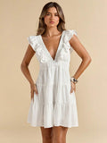 Close-up white mini dress with deep V neckline ruffled shoulders elastic waist and tiered skirt