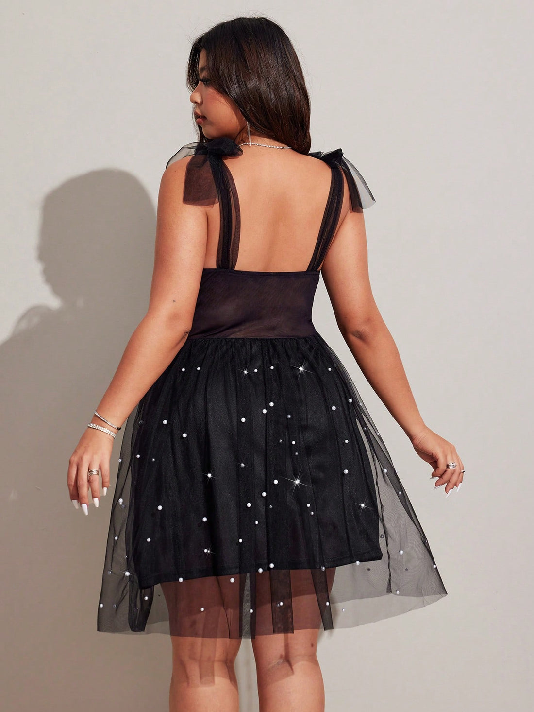 Turn heads effortlessly in this plus size A-line dress featuring delicate spaghetti straps, sheer mesh accents, and charming pearl details. Designed to flatter your curves while adding a touch of playful elegance, it’s the perfect choice for a memorable date night. Feel confident, flirty, and fabulous all evening long.