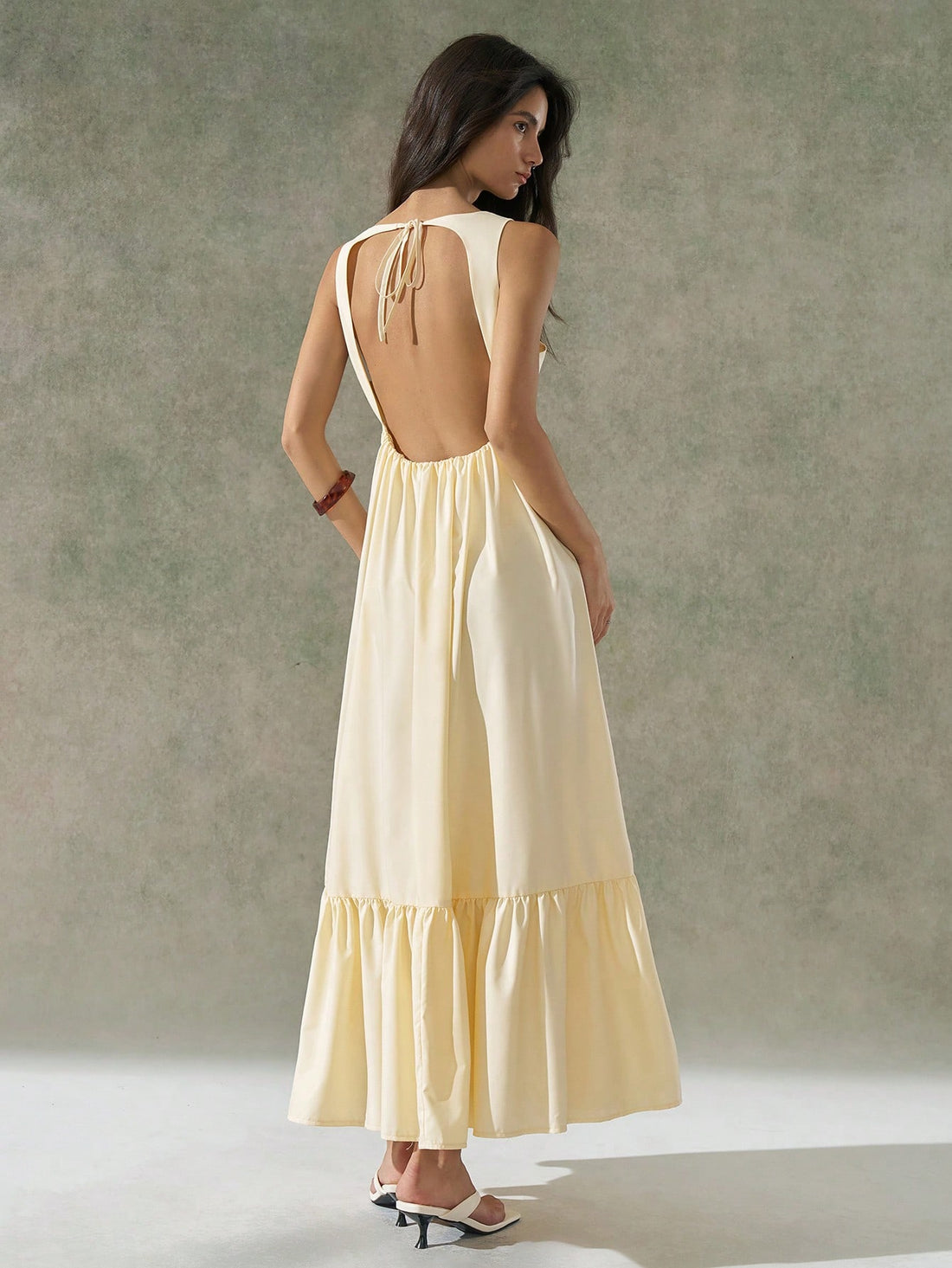 Step into sunshine with this playful light yellow dress, perfect for brightening your spring and summer days. Featuring a flirty backless design and a ruched hem that adds a fun twist, it’s made to keep you cool and stylish. Whether you’re out for brunch or dancing under the sun, this dress brings effortless charm to your warm-weather wardrobe.