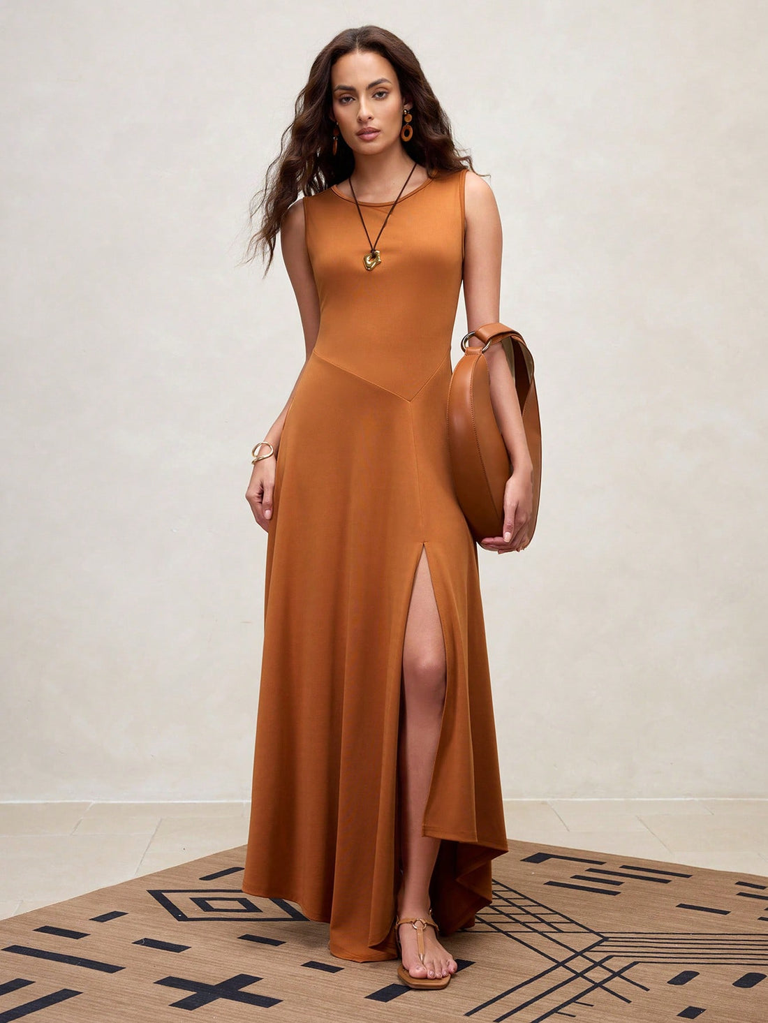 Step into summer with this chic brown sleeveless maxi dress, designed to turn heads with its playful asymmetric hem and daring front slit. Lightweight and breezy, it’s perfect for sunny days and makes a stylish gift for Mother’s Day. Effortlessly elegant, this dress lets you dance through warm evenings with comfort and flair.