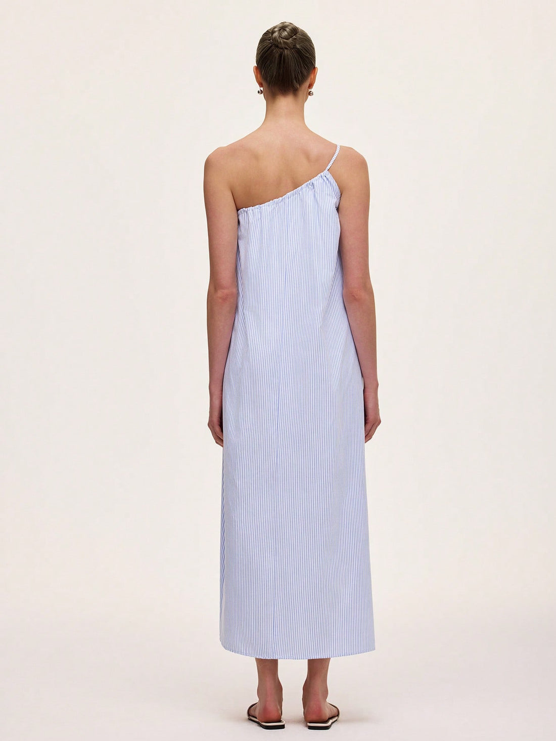 Step out in style with this chic green striped dress featuring a playful asymmetric neckline and sleeveless design. Its unique cut adds a fun twist to elegance, perfect for turning heads at any event. Lightweight and flattering, it’s your go-to for effortless sophistication with a splash of personality.