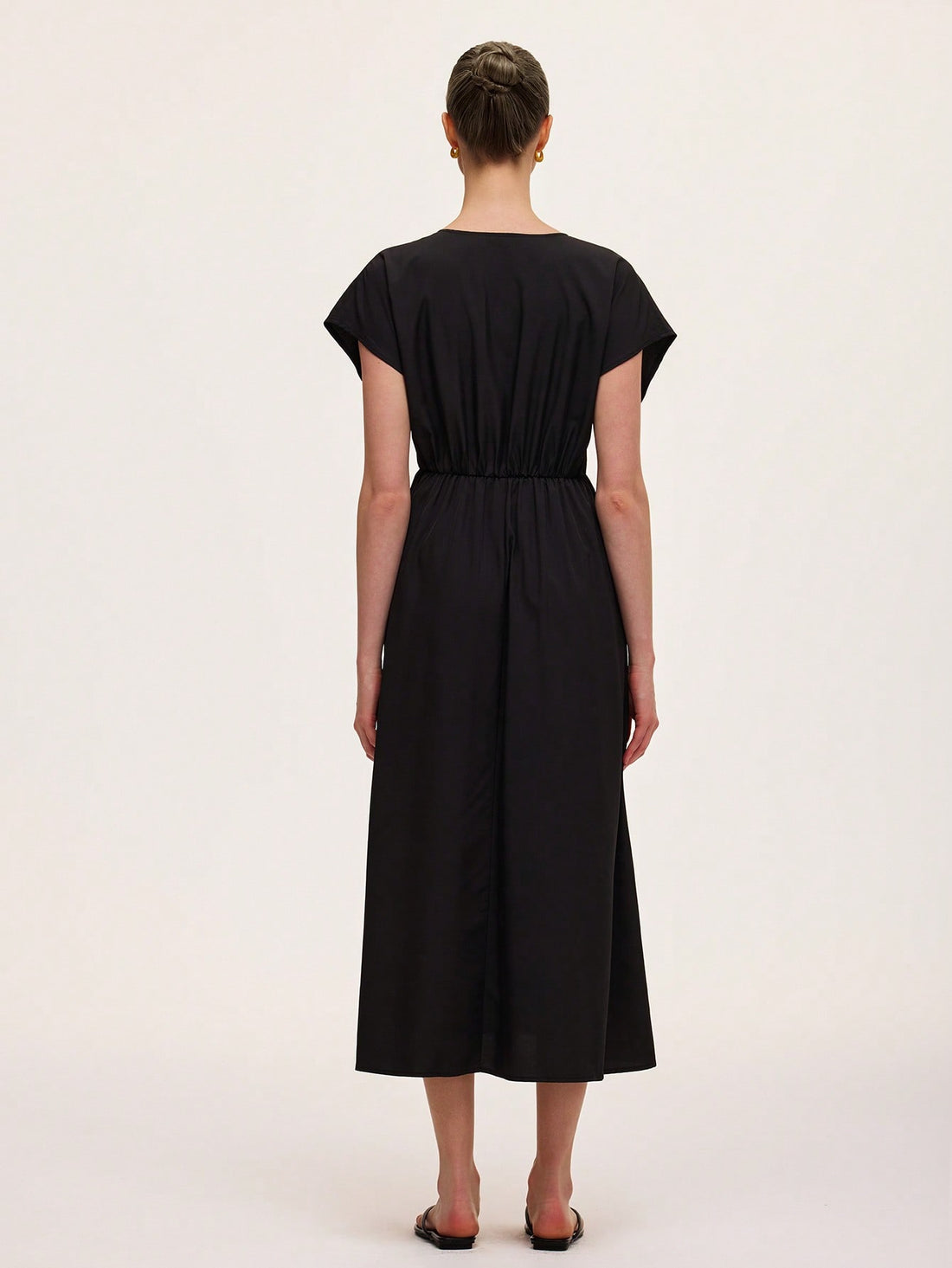 Step out in style with this chic black V-neck dress featuring a flattering draped design and a cinched waist that effortlessly highlights your silhouette. Perfect for any occasion, it combines comfort and elegance with a playful twist, making you feel confident and ready to turn heads wherever you go.