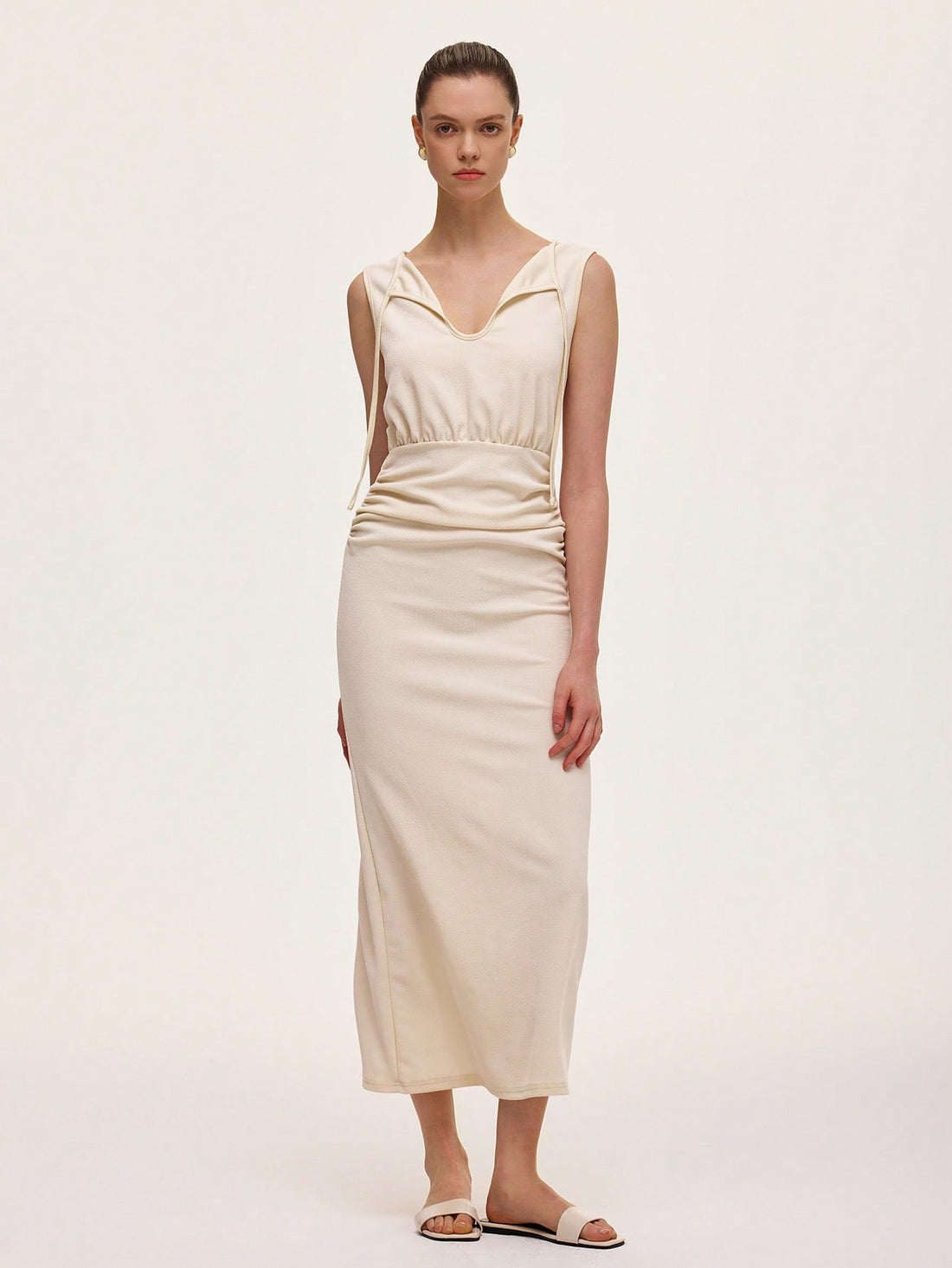 Step into effortless elegance with this chic ivory midi dress. Featuring a flattering V-neck and ruched waist, it highlights your silhouette while keeping things light and breezy with its sleeveless design. Perfect for any occasion where you want to feel stylish and comfortable without trying too hard.