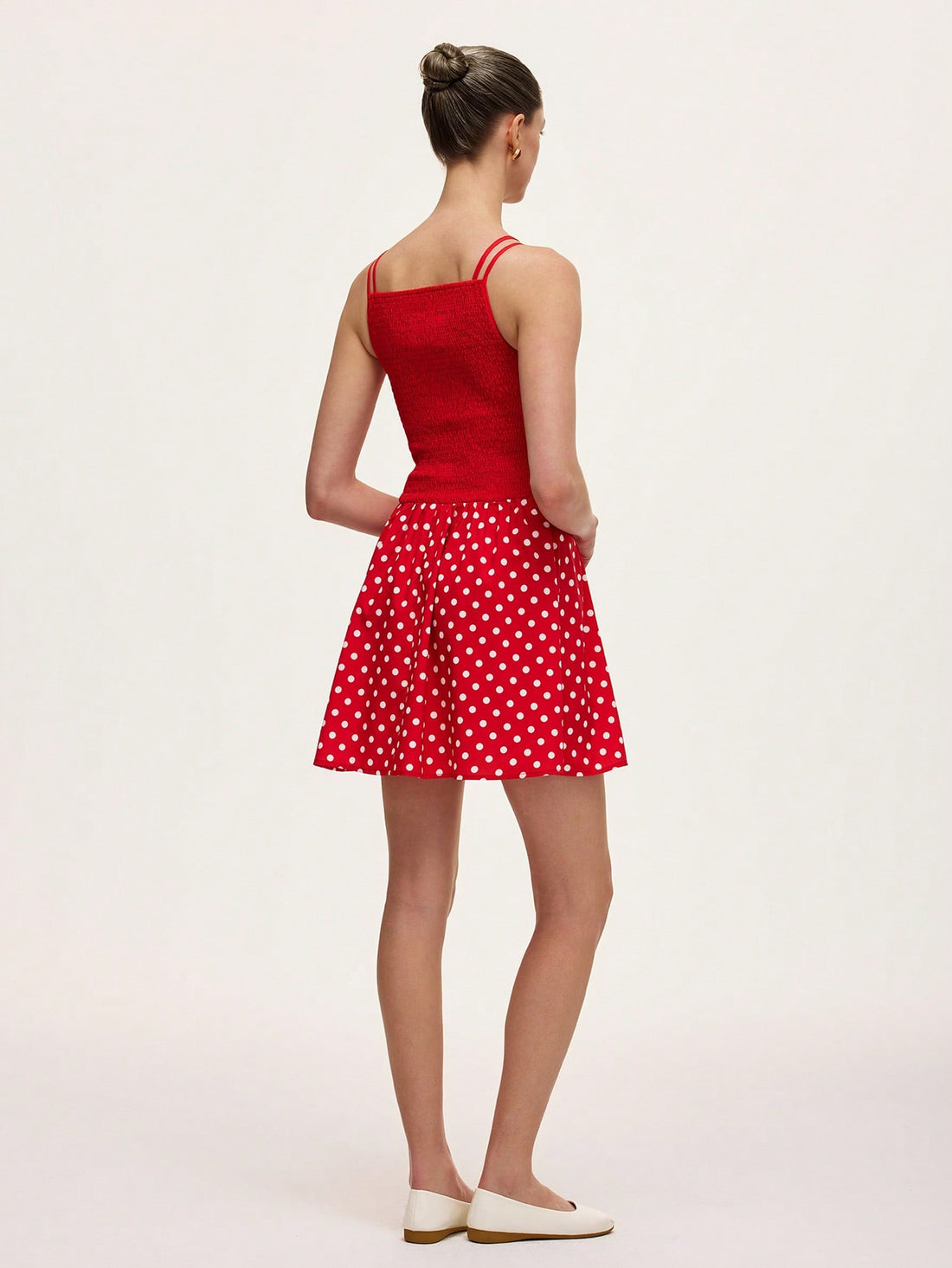 Step into summer with this playful green and red polka dot cami dress. The ruched detailing adds a flirty touch, while the lightweight fabric keeps you cool and comfortable. Perfect for sunny days and stylish nights, this dress brings fun and flair to your warm-weather wardrobe.