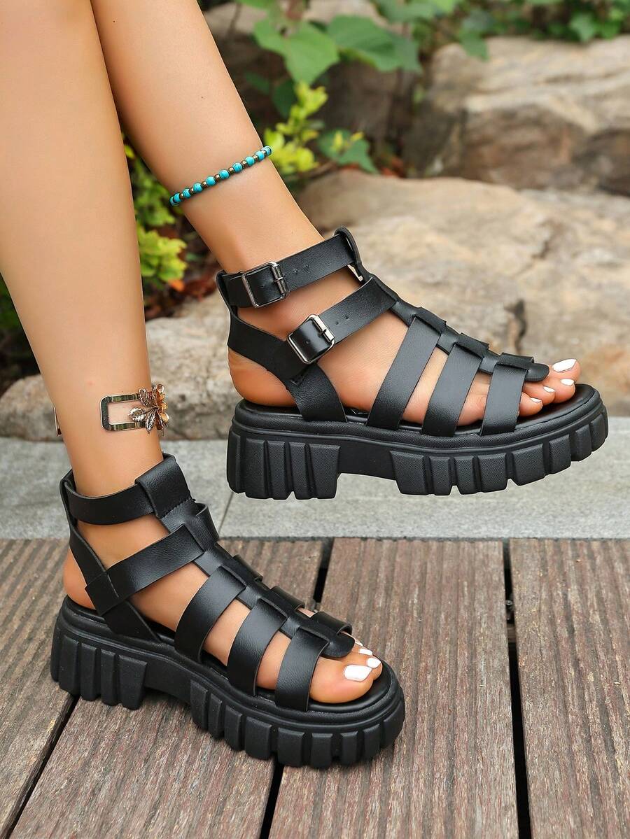 Elevate your summer style with these striking women's Roman sandals, designed for both fashion and function. Featuring a bold punk aesthetic, these black wedge sandals showcase a criss-cross upper with a convenient zipper back closure and hollow design elements for breathability. The round toe and ankle strap provide secure support, while the mid-heel platform offers comfortable elevation. Crafted from premium PU leather throughout with a polyfoam outsole, these versatile sandals transition seamlessly from 