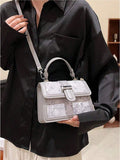 Black floral shoulder bag with turn lock