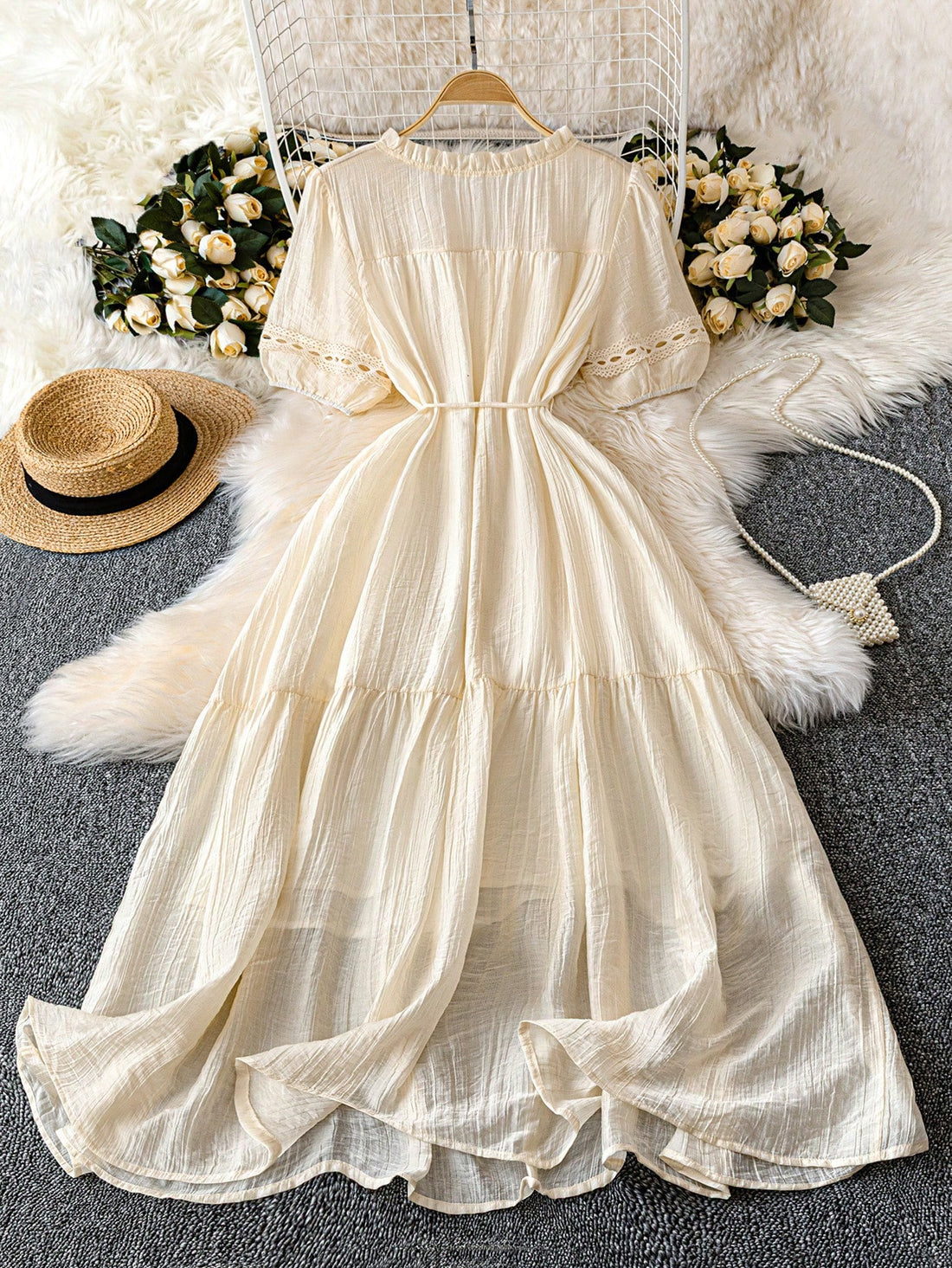 Embrace your romantic side in this plus size pale peach dress, featuring a playful textured fabric and a flirty ruffle hem. The flounce neckline adds a touch of whimsy, while the tassel waist tie lets you cinch in your silhouette for a flattering fit. Perfect for dreamy dates or special outings, this dress combines comfort and charm effortlessly.
