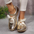 Front view of metallic gold round-toe sneakers styled with white trousers