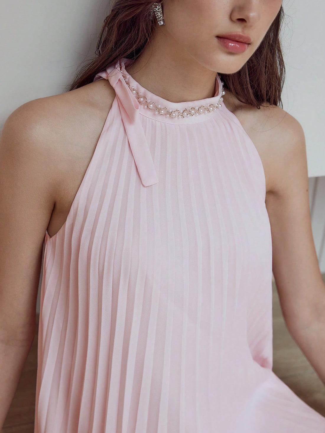 Step out in style with this Elegant Pleated Dress featuring charming faux pearl accents. Its flowing pleats add graceful movement, while the delicate pearl detailing brings a touch of whimsy and sophistication. Perfect for turning heads at any event, this dress combines playful elegance with timeless flair.