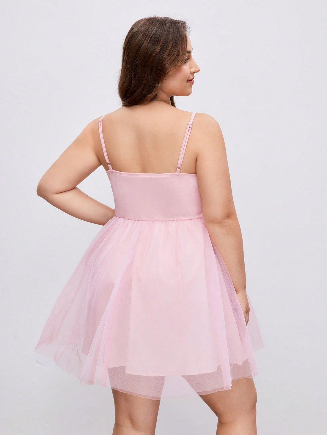 Step into summer celebrations with this playful plus size dusty pink layered mesh slip dress. Its soft, airy layers create a flirty silhouette perfect for dancing the night away at parties or making a graceful entrance at graduations. Lightweight and breathable, it keeps you cool while turning heads with its charming blush hue. Embrace effortless elegance and fun in one stunning dress!