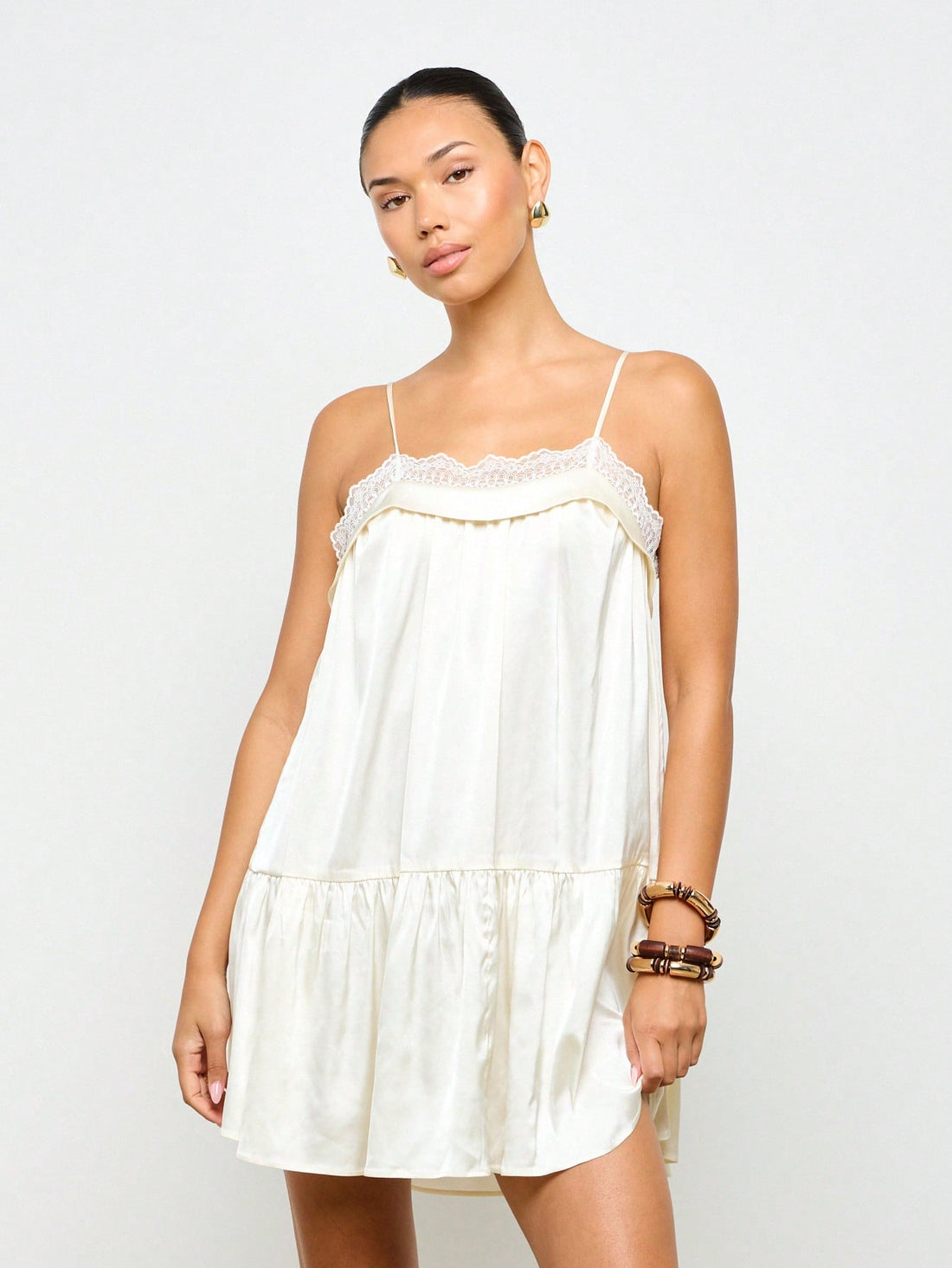 Turn heads effortlessly in this silky satin mini slip dress, featuring a flirty drop waist and delicate lace trim. Its lightweight, smooth fabric keeps you cool and comfy, making it your go-to for weddings, beach getaways, or laid-back summer parties. Embrace easy elegance with a playful twist!