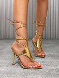 Low front view of metallic gold square-toe lace-up stiletto sandals