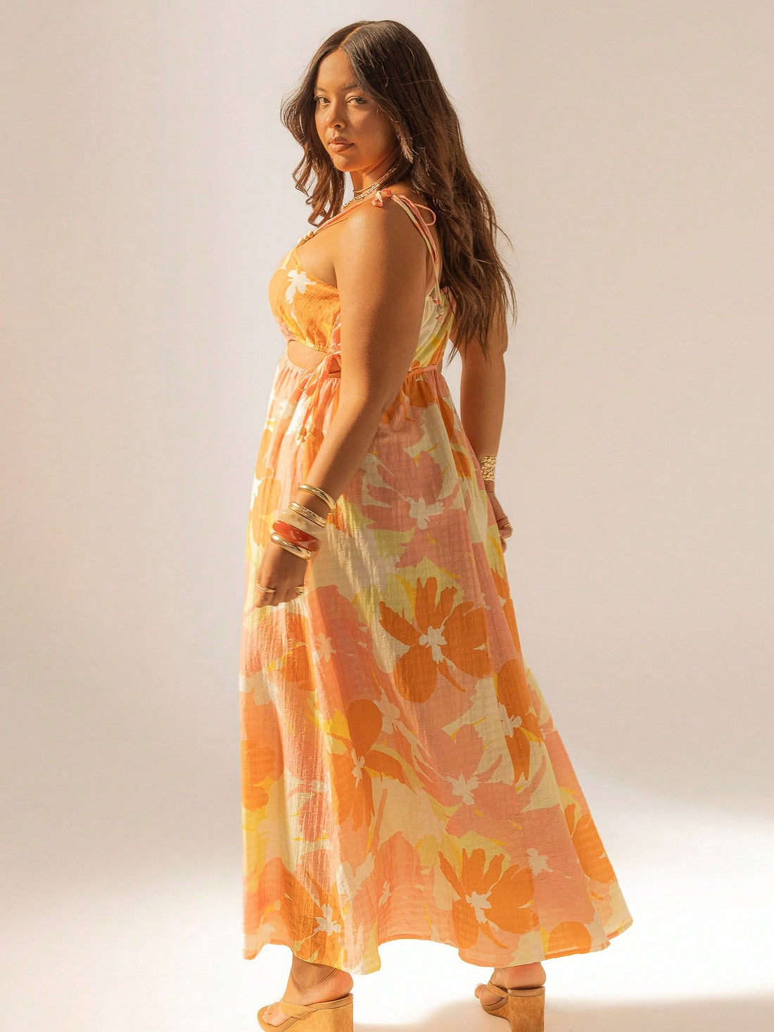 Embrace the sunshine in this Bohemian Floral Maxi Dress, perfect for summer beach getaways. Featuring breezy cut-outs and playful tie straps, it blends comfort with a fun, free-spirited vibe. Its flowing silhouette and vibrant floral pattern make every step feel like a dance along the shore. Get ready to turn heads and soak up the sun in effortless style!