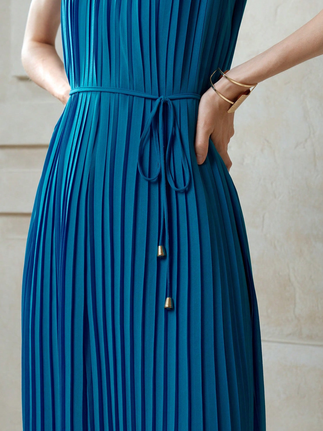 Step into summer with this playful blue chiffon dress, designed to keep you cool and stylish on vacation. Its breezy pleats and flattering V-neck create effortless elegance, while the sleeveless cut lets you soak up the sun with ease. Perfect for beach strolls or sunset dinners, this dress combines comfort and charm for your carefree getaway.