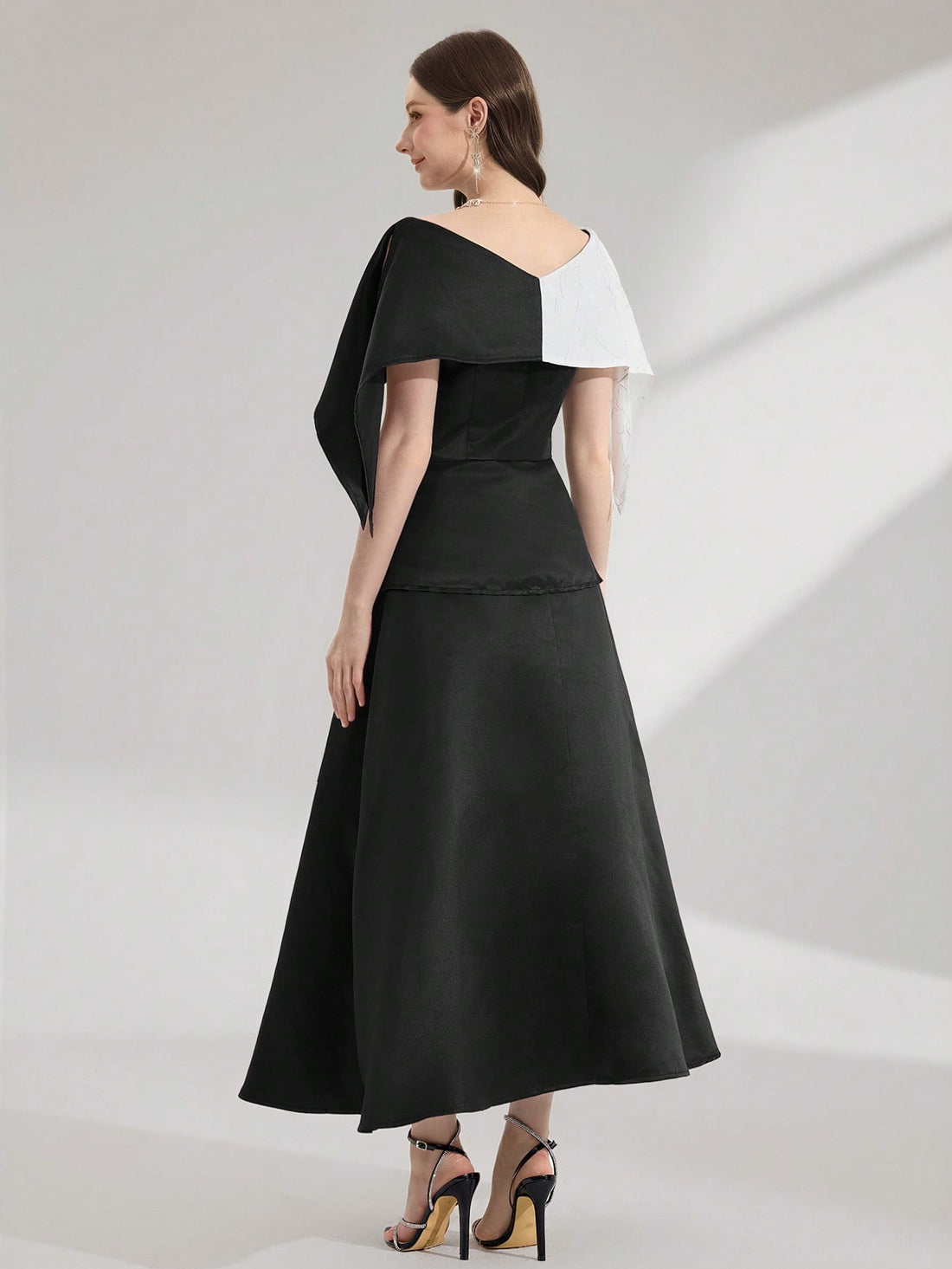 Step into the spotlight in this stunning color block evening gown that's equal parts sophisticated and show-stopping. The luxurious black patchwork design creates an eye-catching visual that commands attention at any event—whether you're dancing the night away at prom or turning heads at an elegant soirée. Expertly crafted with a flattering silhouette, this dress transforms you into the main event. Perfect for those moments when you want to feel absolutely fabulous and unforgettable.