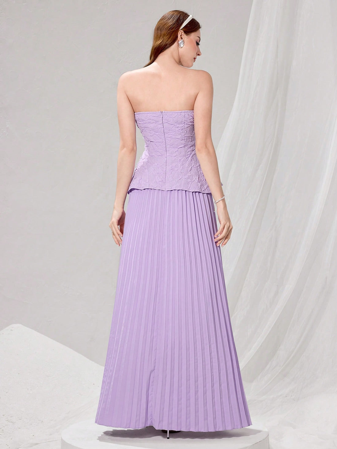 Make a grand entrance in this stunning strapless evening gown that's pure sophistication with a fun twist. The delicate lace bodice pairs beautifully with graceful pleated skirt details, creating an effortlessly chic silhouette perfect for weddings and formal celebrations. Whether you're a guest of honor or just looking to turn heads, this dress delivers timeless elegance with just the right amount of flair. Slip into something spectacular and let your confidence do the talking!