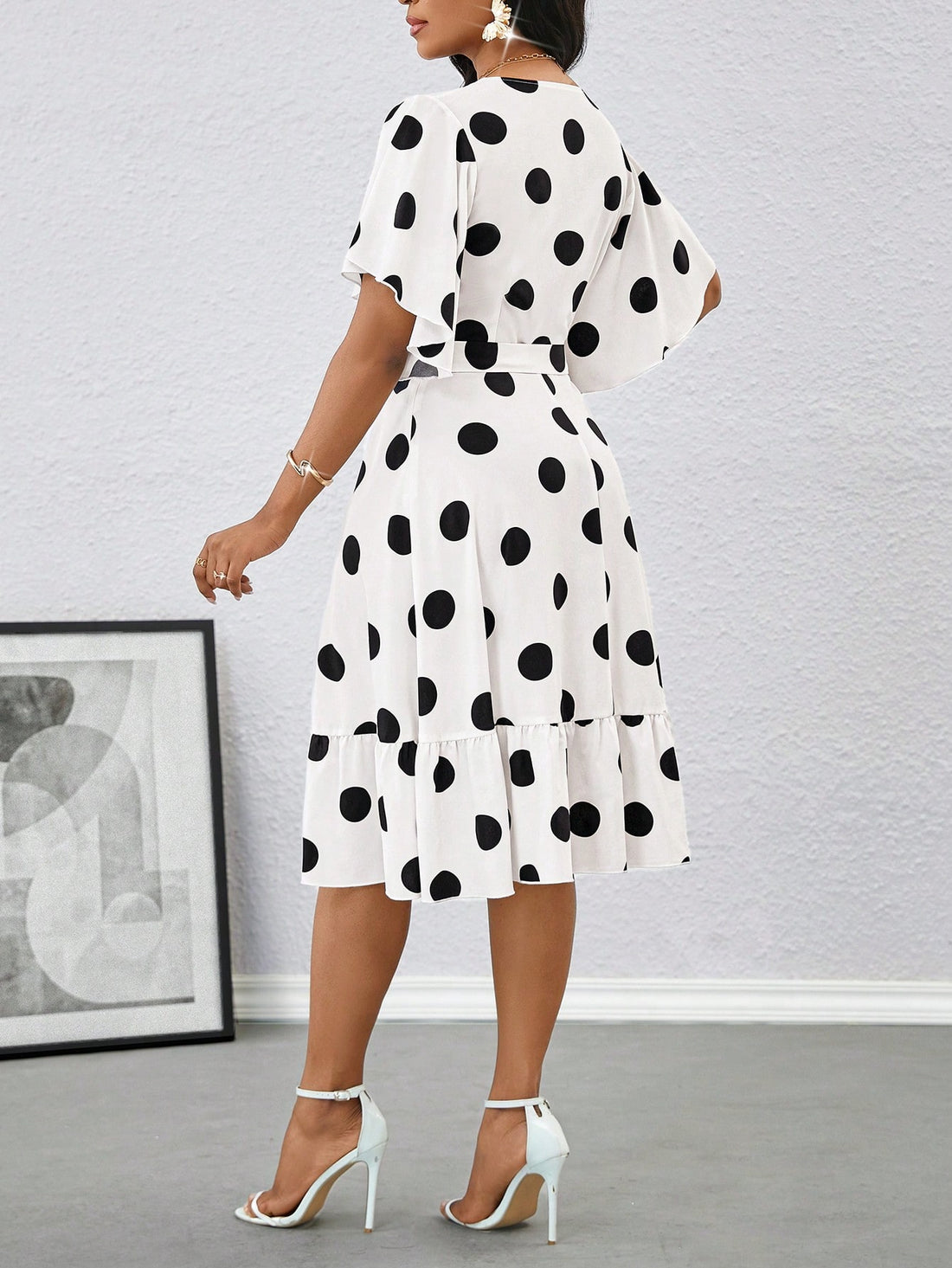 Unleash your inner fashionista with this elegant polka dot midi dress! This dress features playful ruffle sleeves and a self-tie belt for a flattering and stylish look. Perfect for summer, this dress will have you looking and feeling stylish and confident. Go ahead, add it to your wardrobe! (Fashion-forward, stylish, flattering)