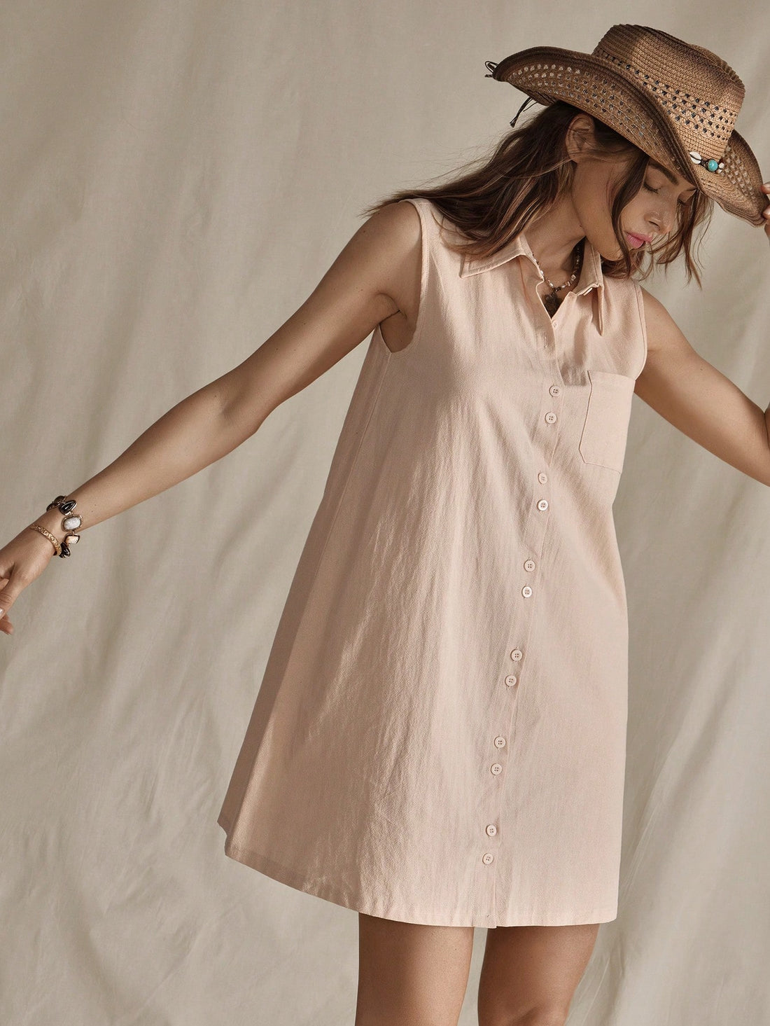 Step into summer with this playful apricot sleeveless mini dress, perfect for channeling chic cowgirl vibes. Its breezy design keeps you cool while the vibrant apricot hue adds a splash of sunshine to your day. Whether you're heading to a festival or a casual outing, this dress offers effortless elegance with a fun, flirty twist.