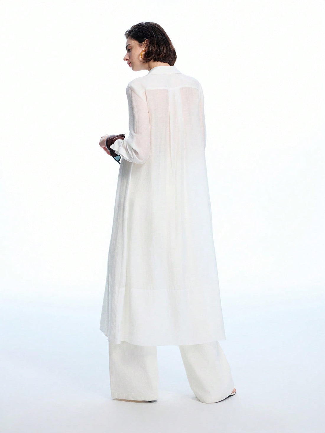 Step into effortless boho chic with this minimalist ruched white semi-sheer shirt dress. Its delicate fabric and subtle ruching create a breezy, flattering silhouette perfect for sunny days or casual nights out. Light and airy, it’s your go-to piece for adding a touch of playful elegance to any wardrobe.
