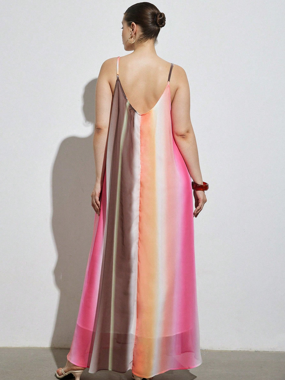 Celebrate vibrant style and comfort with this plus-size maxi dress featuring a playful rainbow gradient. Its flattering V-neck and sleeveless design keep you cool and confident, perfect for casual outings or beach days. Flowing fabric moves with you, making every step feel like a breeze of fun and color.
