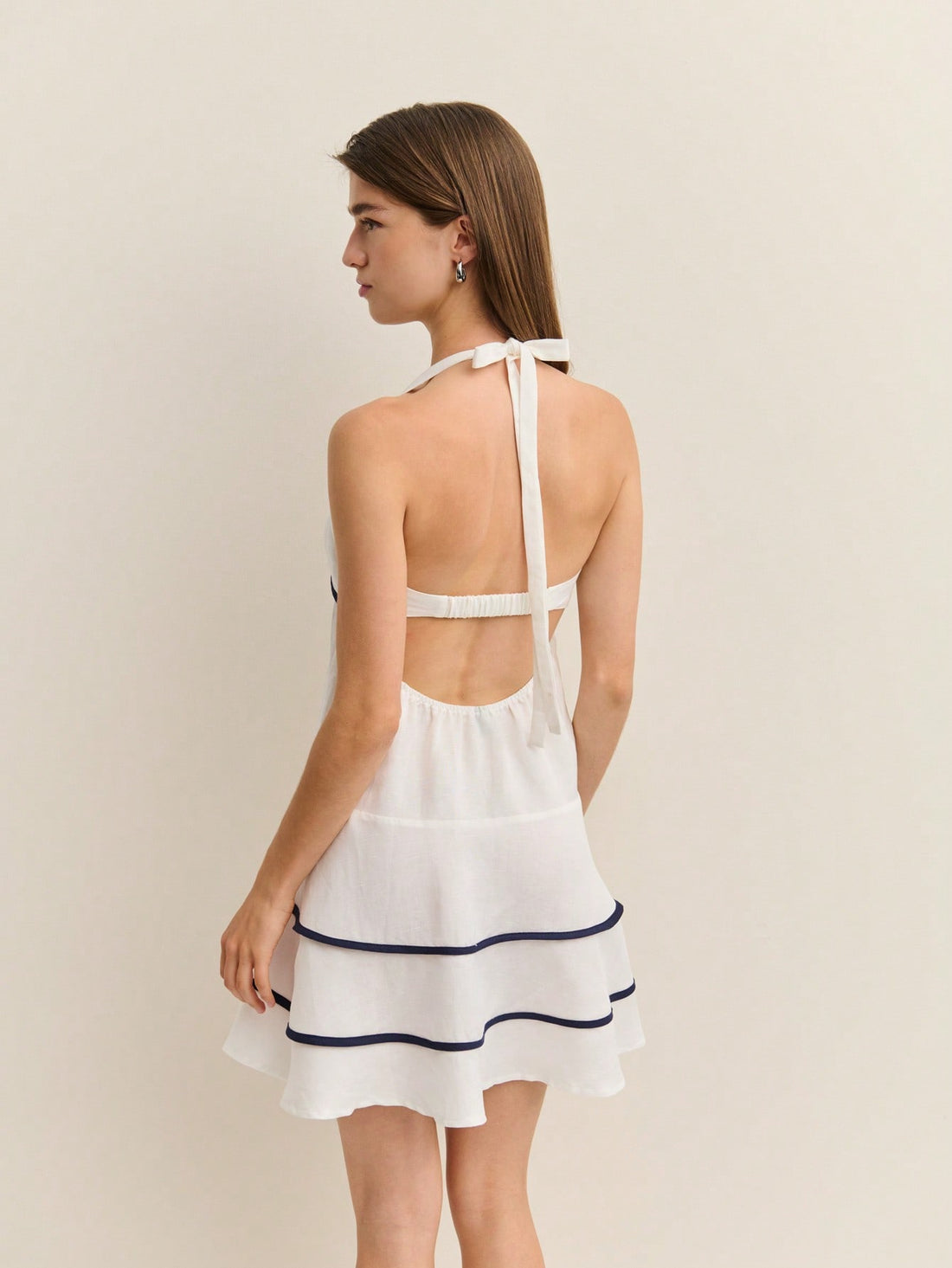 Elevate your event wardrobe with this stunning A-line mini dress, where sharp contrast piping meets effortless elegance. Perfect for graduation celebrations or tropical getaways, this playful piece combines a flattering silhouette with eye-catching details that turn heads. The crisp piping accents frame your figure beautifully while adding a modern twist to a timeless style. Whether you're walking across the stage or sipping cocktails by the beach, this dress delivers chic sophistication with a fun, confide
