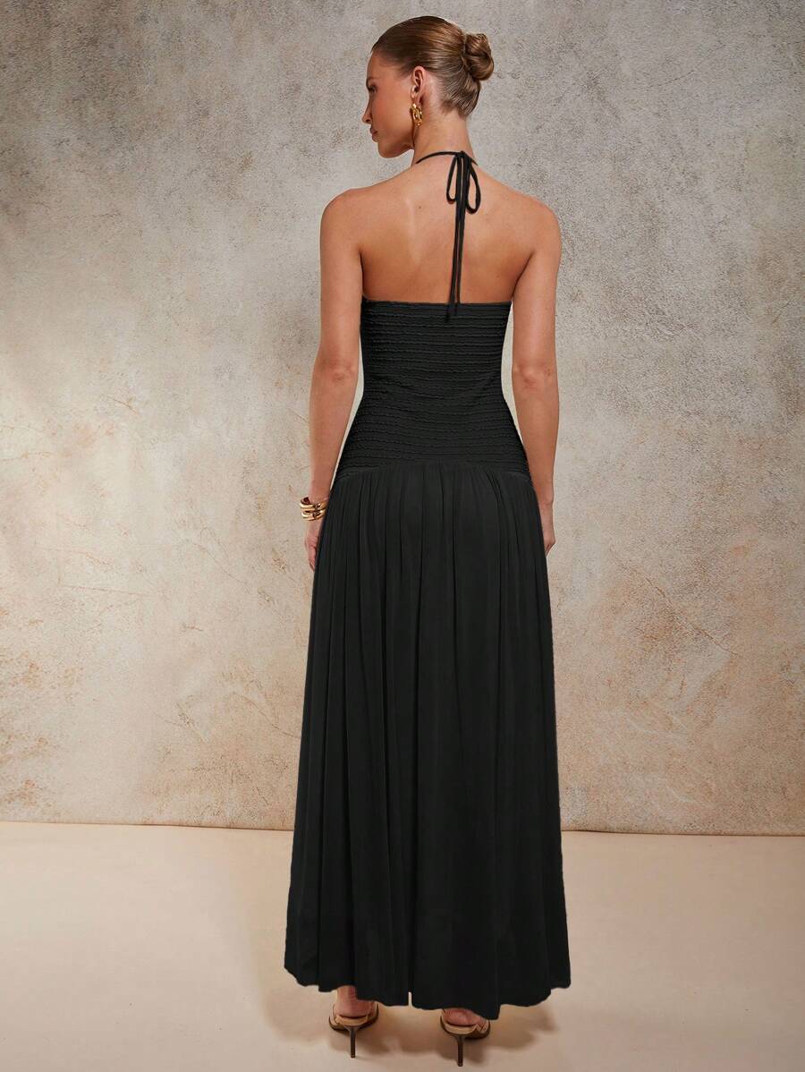 Slip into sophistication with this stunning dark blue halter maxi dress that's equal parts glamorous and fun. The sleek halter neckline frames your shoulders beautifully, while shimmering metal accents add just the right amount of sparkle to catch every eye in the room. Perfect for evening events, special occasions, or whenever you want to feel absolutely fabulous. The flowing maxi silhouette offers comfort without compromising on style, making this dress your go-to choice for turning heads with effortless 
