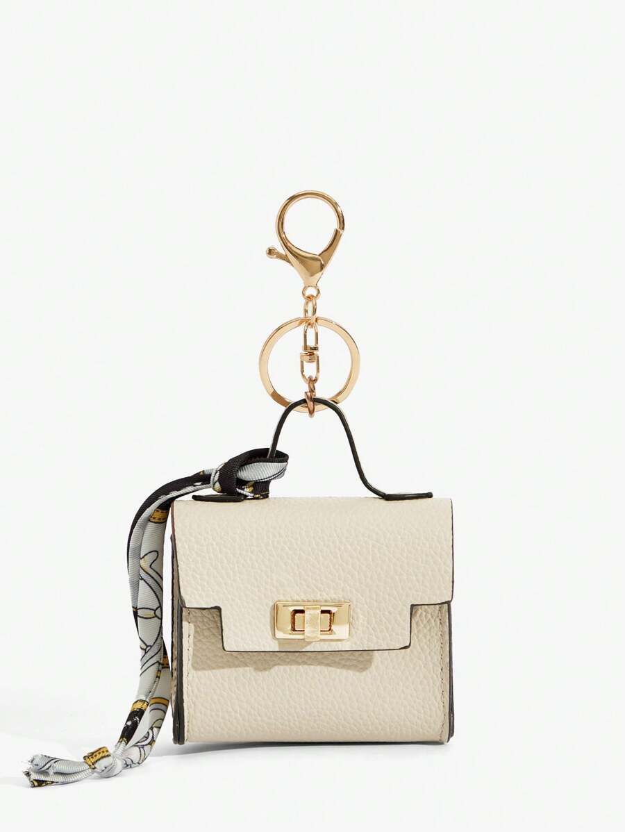Close-up view of mini key ring holder keychain coin purse earphone pouch bag charm with chain strap, coin purse format, key ring detail for small-item storage