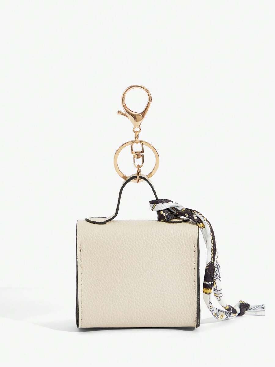 Close-up view of mini key ring holder keychain coin purse earphone pouch bag charm with chain strap, coin purse format, key ring detail for small-item storage