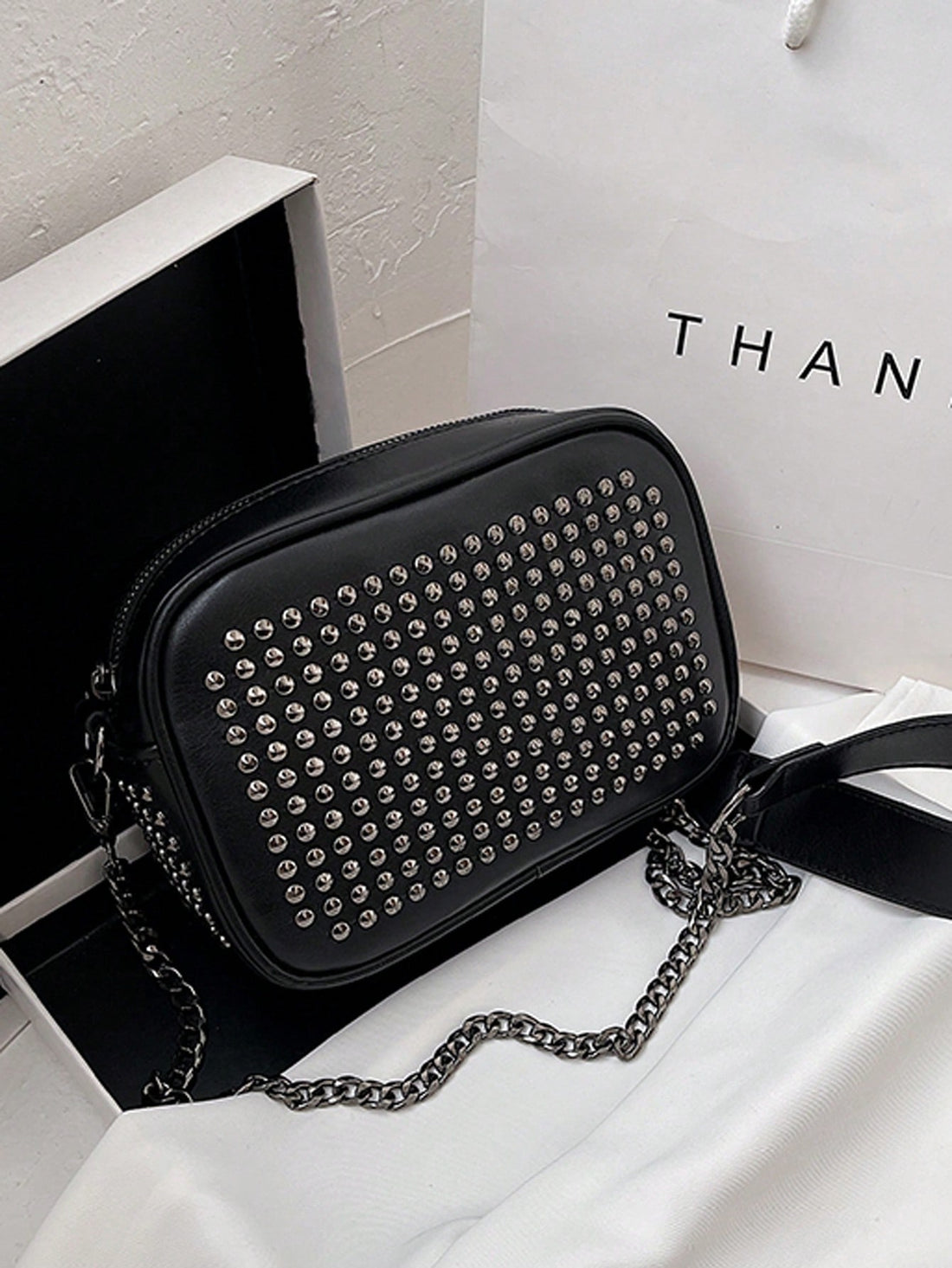 Make a statement with this eye-catching vintage-inspired shoulder bag that effortlessly transitions from day to night. Adorned with edgy rivet detailing, the sleek PU leather construction offers durability without the fuss. Whether you're heading to a wedding, party, or just running errands, this versatile accessory pairs perfectly with any outfit. The comfortable shoulder strap keeps your essentials within reach, while the timeless design ensures you'll reach for it again and again. Vintage charm meets mod