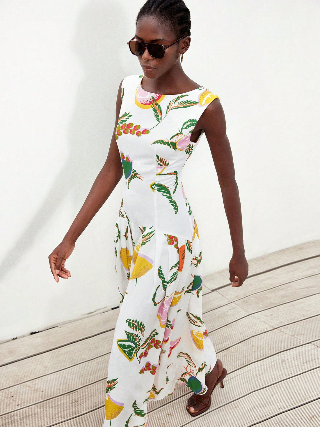 Step out in style with this playful sleeveless dress featuring a charming floral print. The ruffle hem adds a flirty touch, while the waist cinch creates a flattering silhouette perfect for your daily commute or weekend adventures. Light and breezy, it keeps you comfortable and effortlessly chic wherever you go.