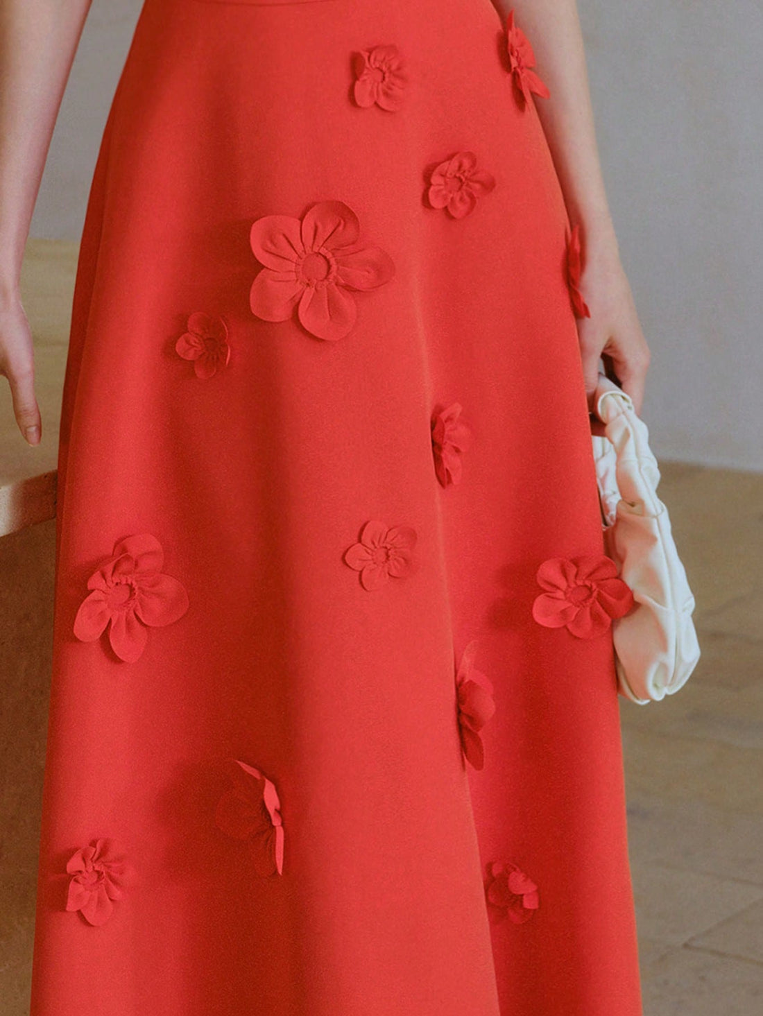 Step out in style with this playful mid-calf dress featuring charming ruffle sleeves and eye-catching 3D floral accents. The cinched waist flatters your figure while the solid color keeps it effortlessly chic. Perfect for twirling through sunny days or making a statement at your next gathering.