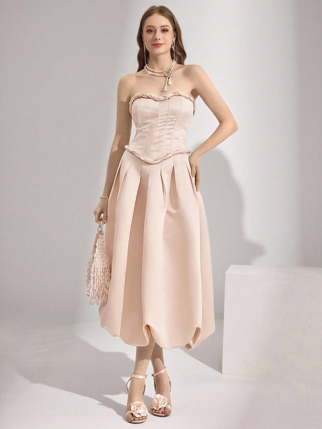 Step into the spotlight in this stunning strapless ball gown that's pure magic. The Poshira dress features exquisite decorative details that catch the light beautifully, creating an unforgettable silhouette perfect for galas, proms, and those "wow, you look amazing" moments. With its elegant strapless neckline and flowing skirt, you'll feel like royalty all night long. Whether you're dancing till dawn or making a grand entrance, this luxurious gown transforms any special occasion into your personal red carp