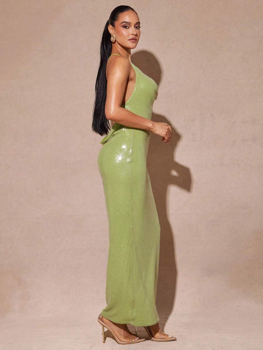 Turn heads wherever you go with this Elegant White Sequin Backless Dress! Its sparkling sequins catch the light perfectly, while the daring backless design and playful side slit add a flirty touch. Whether you're dancing at a festival, strolling on vacation, or shining at a special event, this dress brings effortless glamour and fun to every moment.