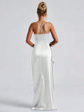 White satin gown front view with narrow straps, side drape and high slit