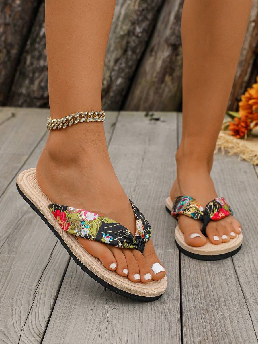 Low front view of padded floral thong flip-flops with a central knot
