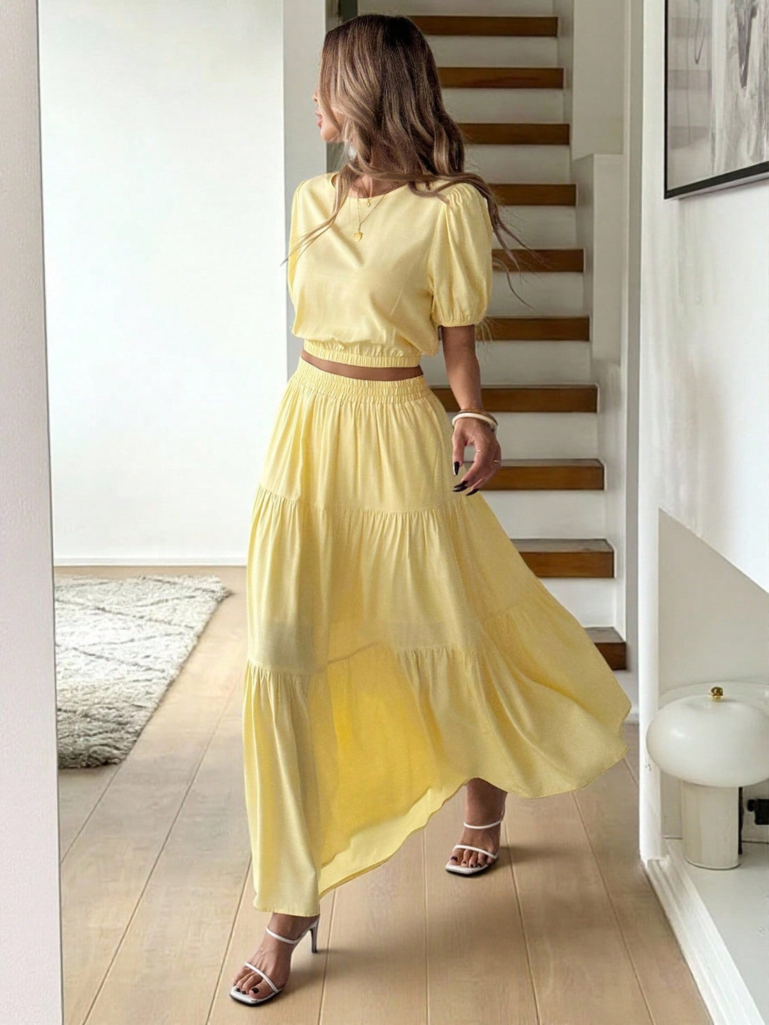 Escape to your own private resort with this dreamy two-piece set! The cream puff sleeve blouse features delicate, voluminous sleeves that add a touch of romance and movement to your silhouette. Pair it with the butter yellow A-line midi skirt for an effortlessly chic look that transitions seamlessly from beachside brunch to sunset cocktails. The soft, complementary color palette whispers luxury while the relaxed fit keeps you cool and comfortable all day long. Perfect for vacations, garden parties, or whene